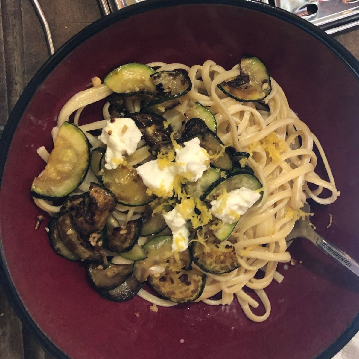 A vibrant dish of fettuccine pasta tossed with zucchini ribbons and creamy goat cheese.