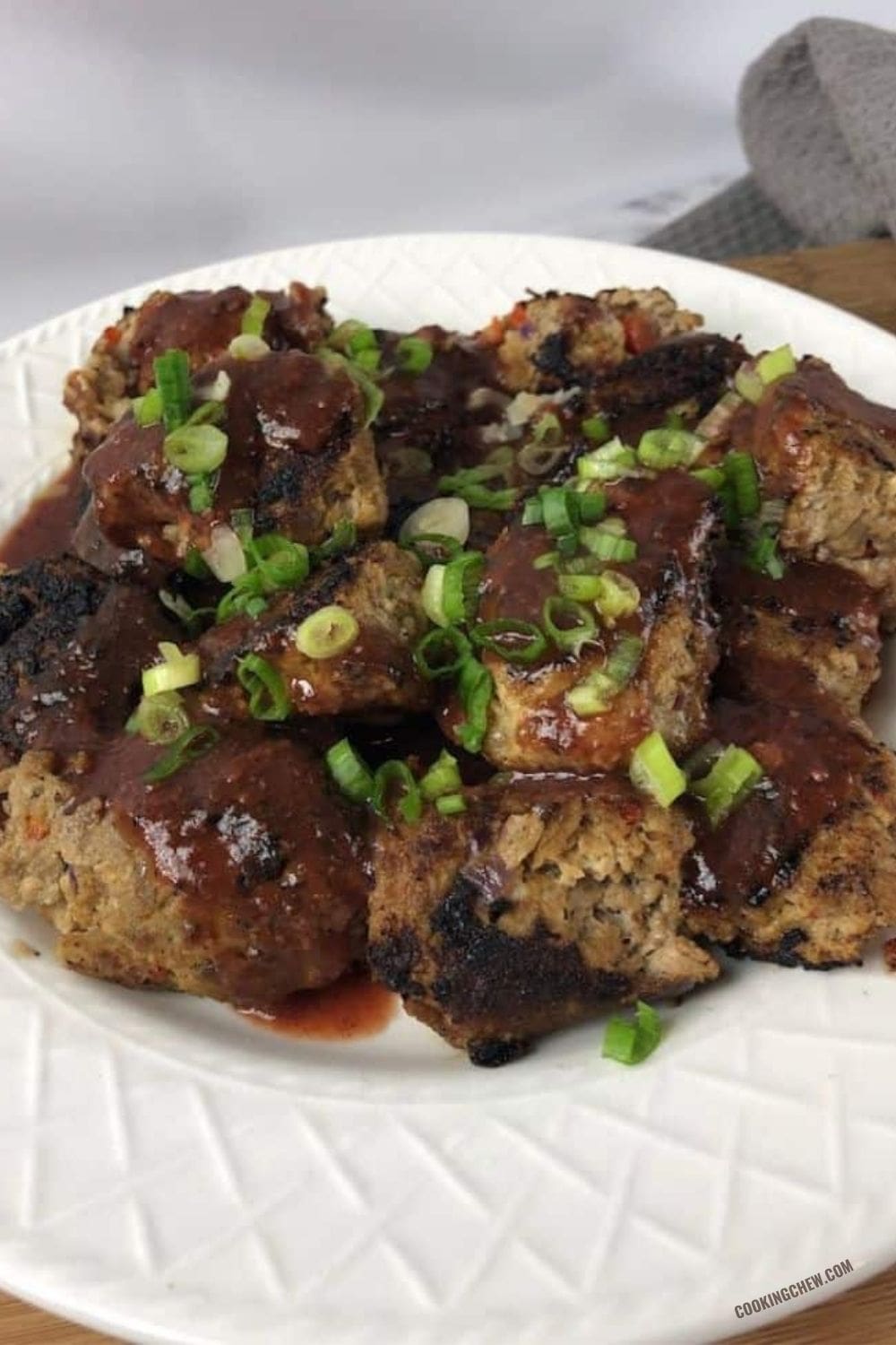 A close-up photo of asian turkey meatball, showing its tender texture and golden brown crust. 