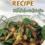 A bowl of roasted pear salad with mixed greens, cheese, and balsamic dressing