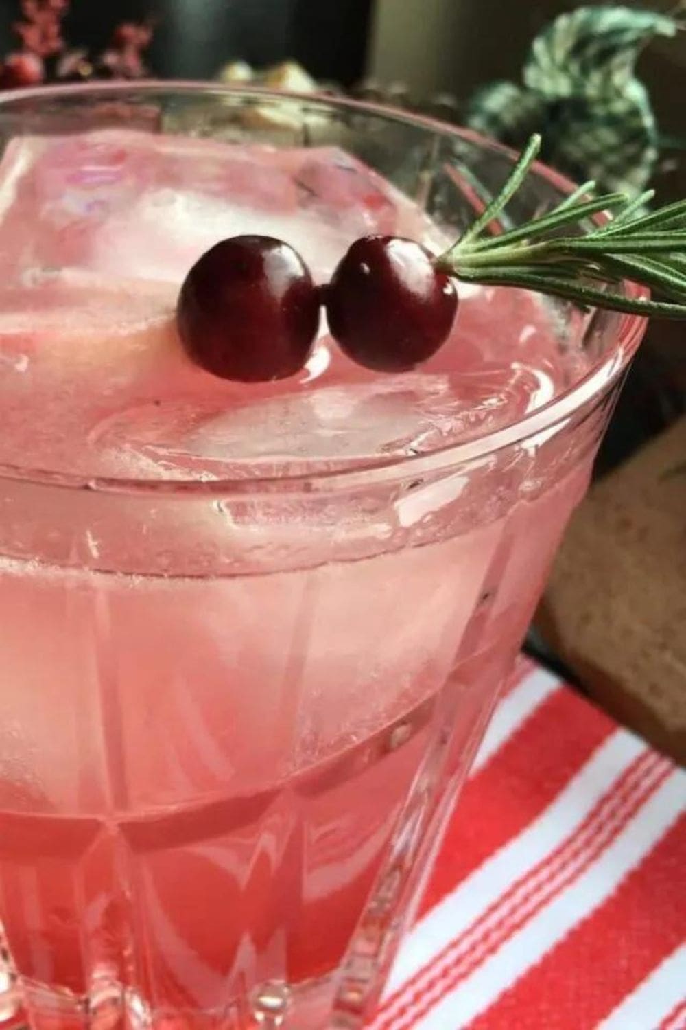 Cranberry Margarita on the Rocks garnished with lime and cranberries