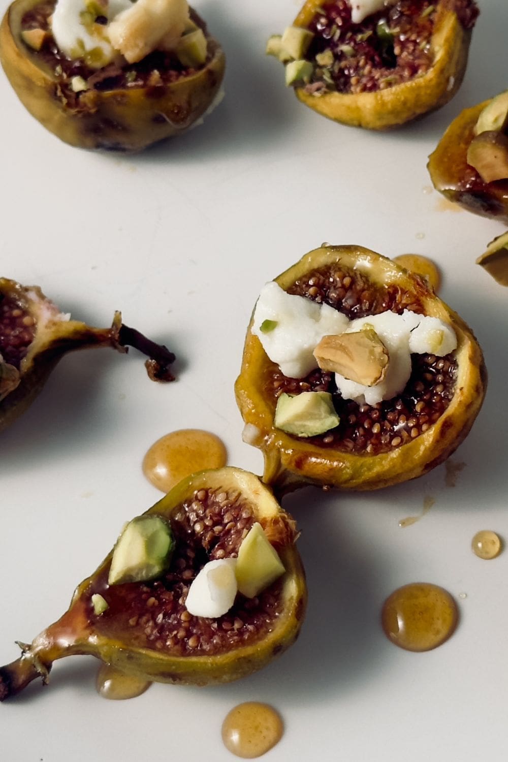 Roasted figs paired with goat cheese and honey for a tasty and elegant appetizer.