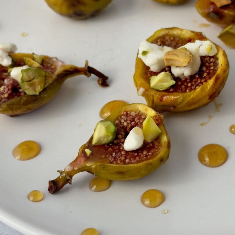 Sweet and savory honey-roasted figs with creamy goat cheese appetizer.