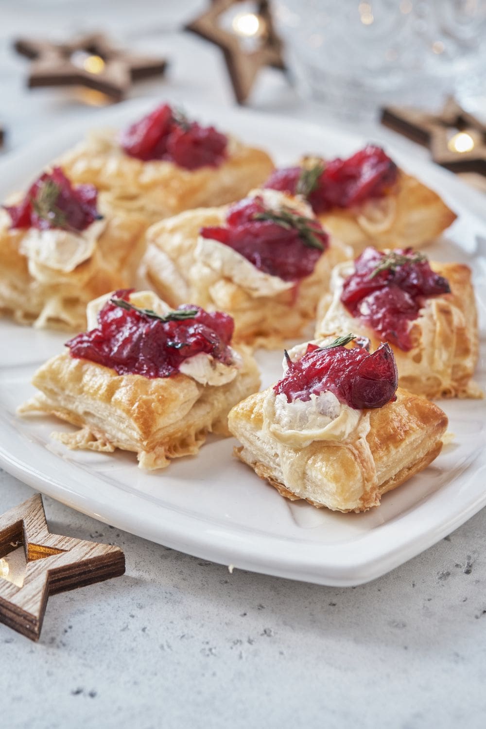 Holiday appetizers with cranberry sauce, brie cheese and thyme