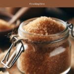 A glass jar filled with brown sugar and a spoon.