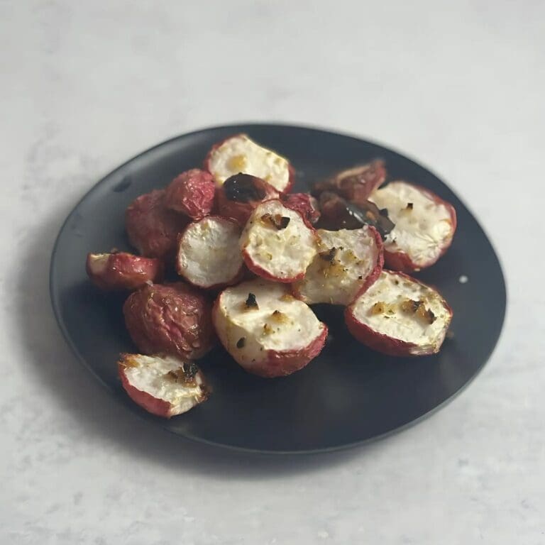 Crispy oven roasted radishes on a baking sheet.