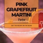 A close-up photo of a chilled pink grapefruit martini in a coupe glass, garnished with a grapefruit twist.