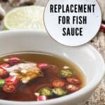 A bowl of fish sauce on a wooden table.