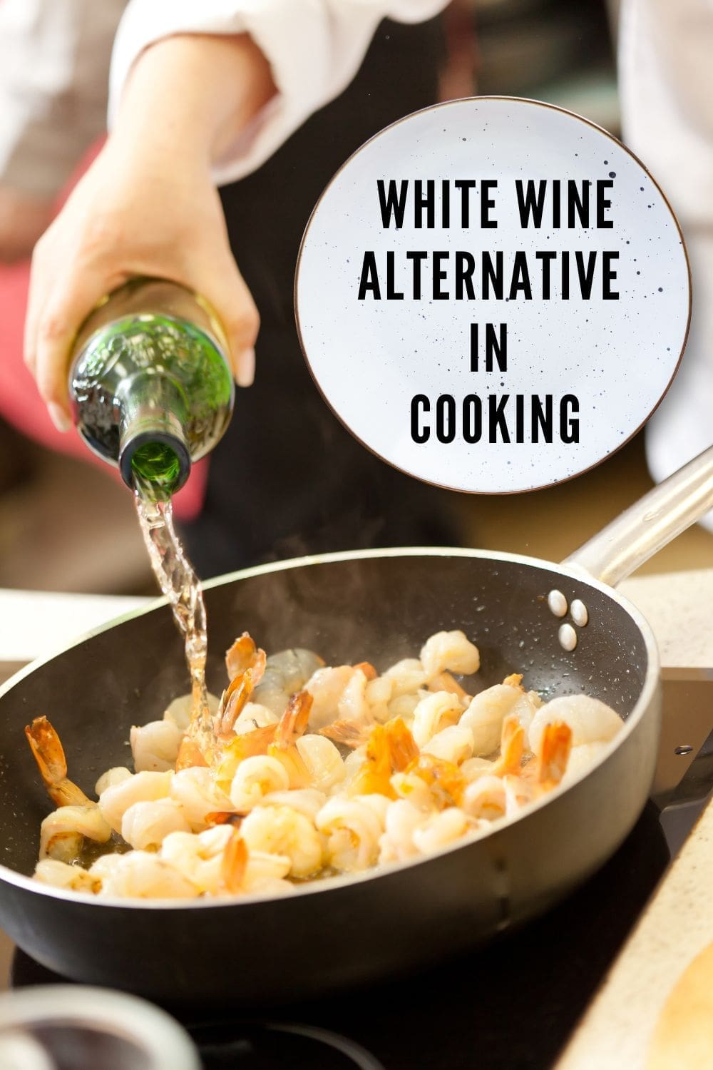 A close-up photo of a chef pouring white wine into a pan of shrimp.