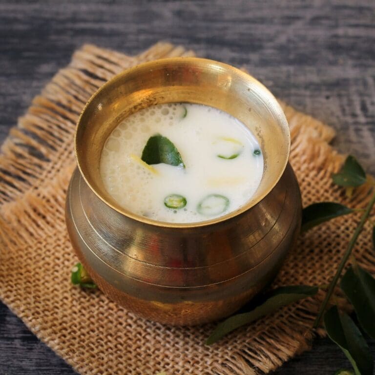 A close-up photo of a bowl of buttermilk on a table.