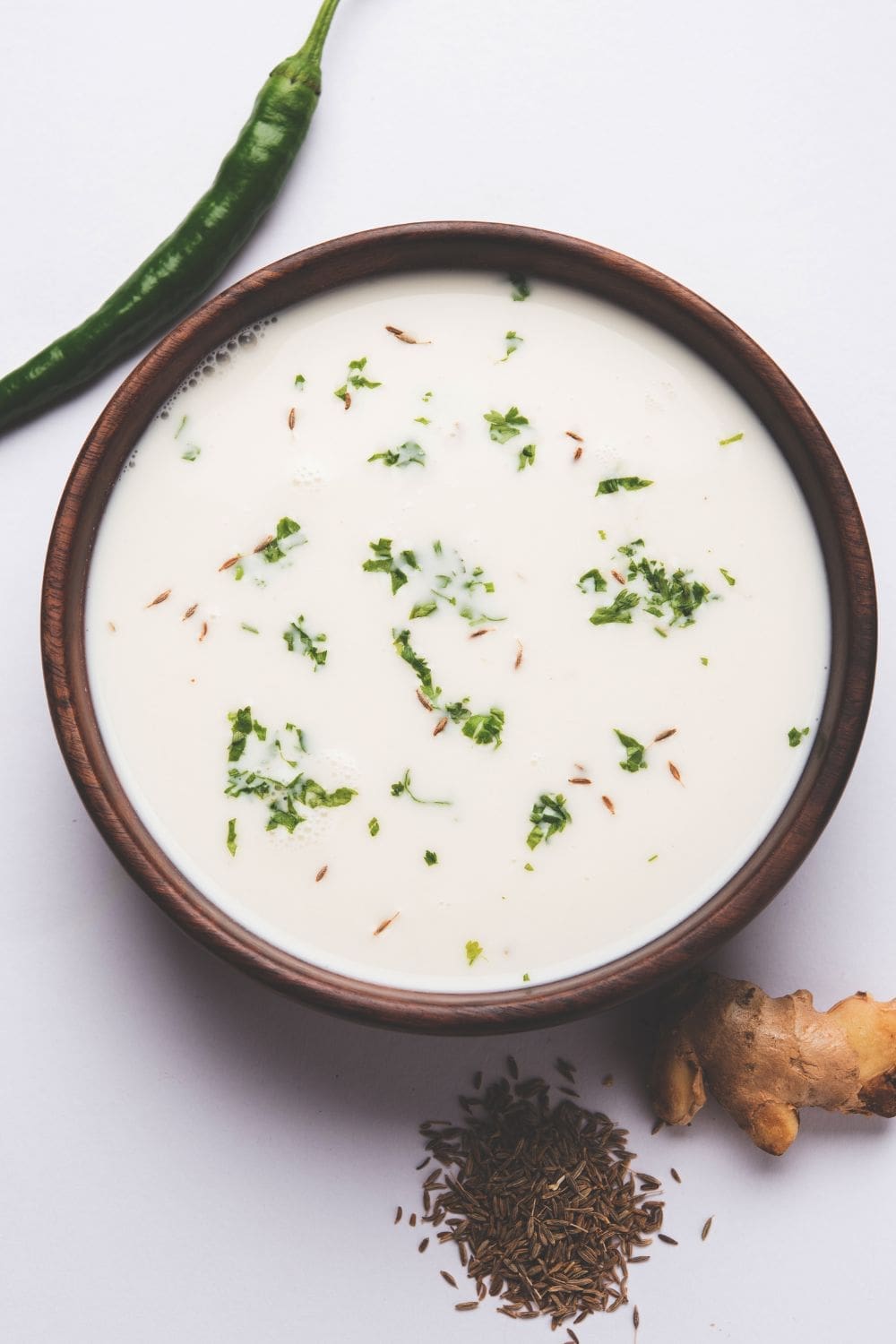 A close-up photo of a bowl filled with buttermilk.