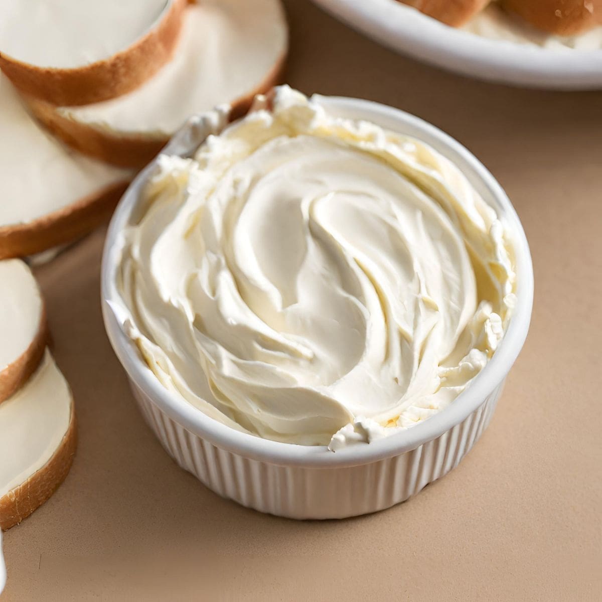 A close-up photo of a bowl of whipped cream cheese.