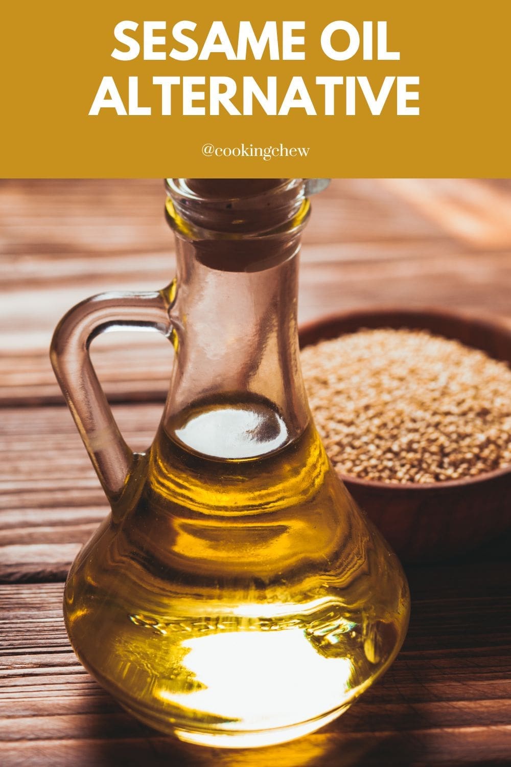 A bottle of sesame oil sits on a wooden table next to a small bowl of sesame seeds. 