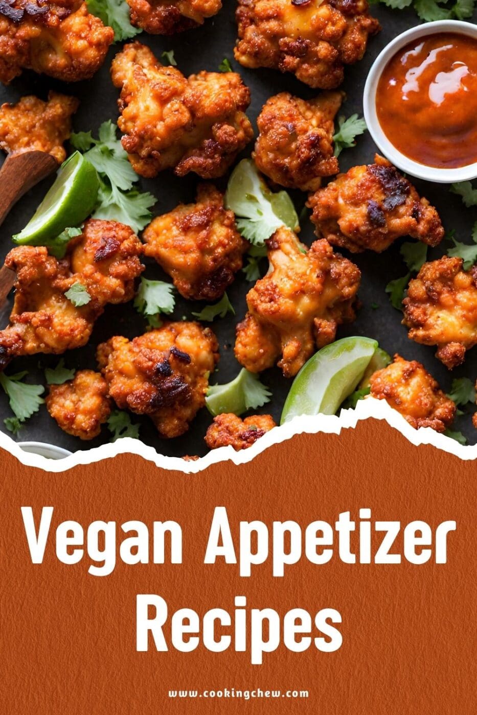A plate of chipotle cauliflower wings with a slice of lime and a bowl of sauce on a table.