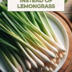 A plate of lemongrass stalks on a wooden cutting board.