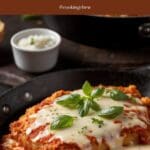 A skillet with a chicken parmesan.