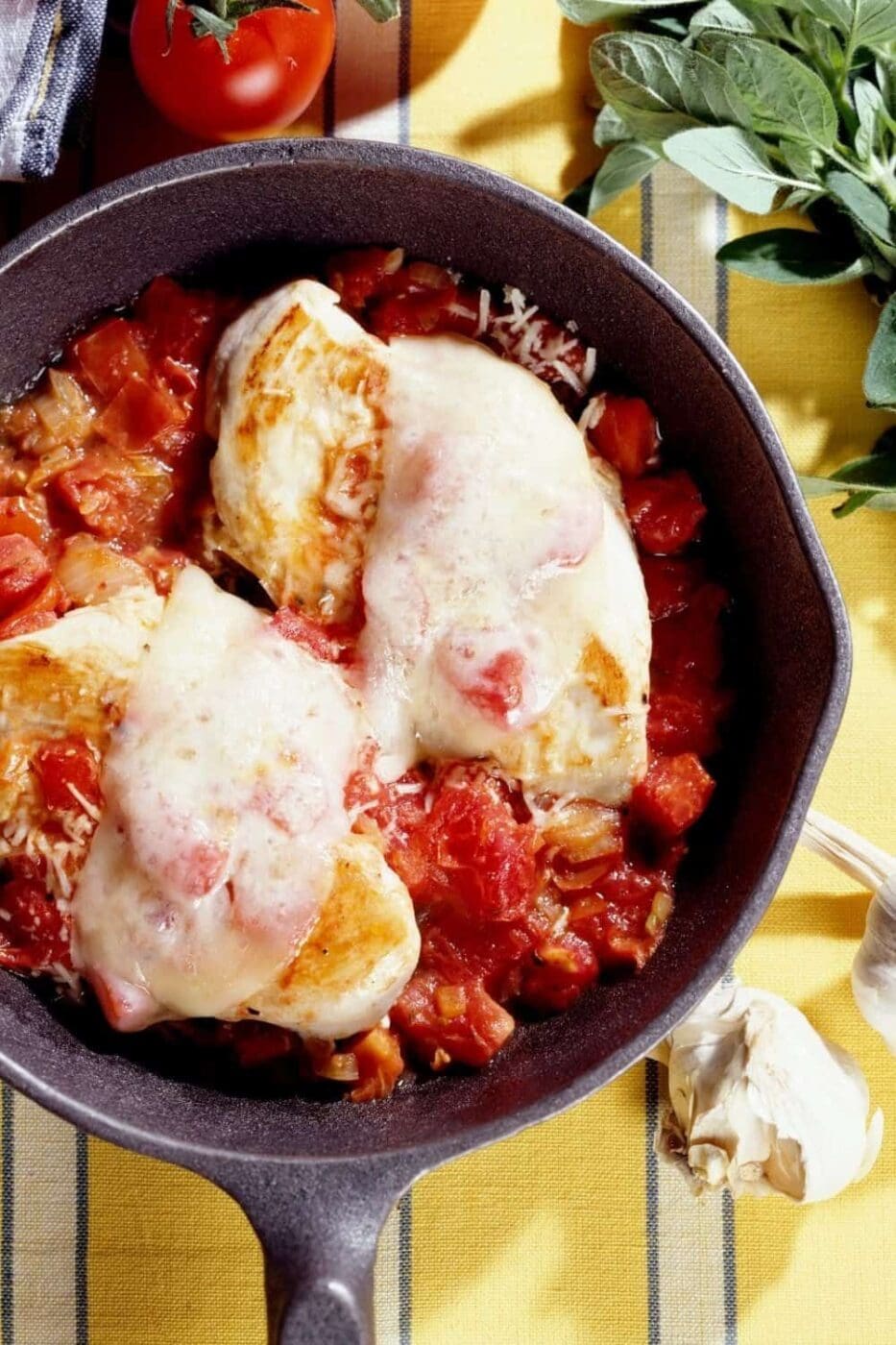 A close-up photo of a skillet with a chicken parmesan.