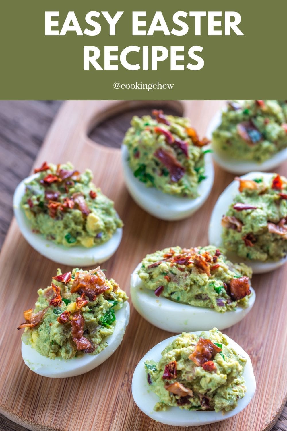 A wooden cutting board topped with deviled eggs filled with avocado and crumbled bacon.