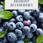 A photo of a pile of blueberries on a wooden table.