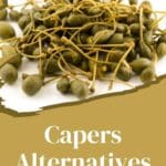 A close-up photo of a pile of capers on a white ceramic plate.