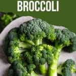 A close-up still life photo of a plate of broccoli florets.