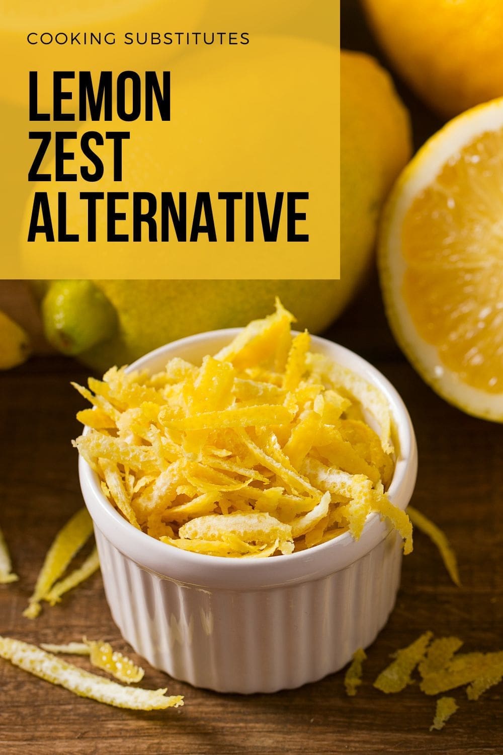 A bowl of freshly grated lemon zest next to lemons on a wooden table.