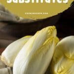 A close-up photo of a cutting board with several endives.