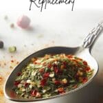 A spoon filled with Italian seasoning, a mixture of dried herbs, on a table.