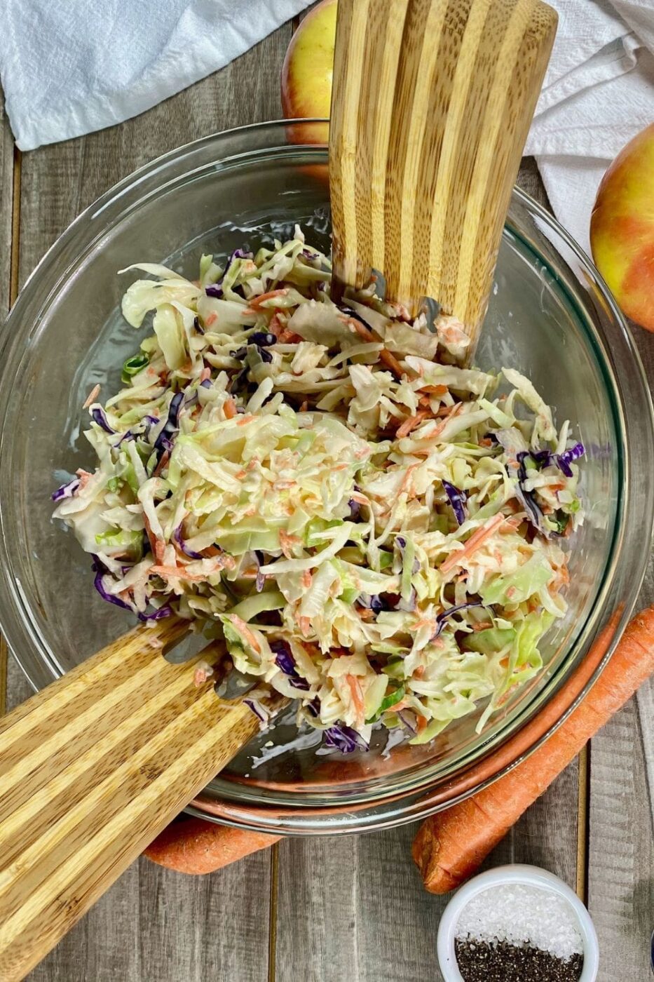 A vibrant bowl of apple carrot slaw with a light, tangy dressing, served fresh.