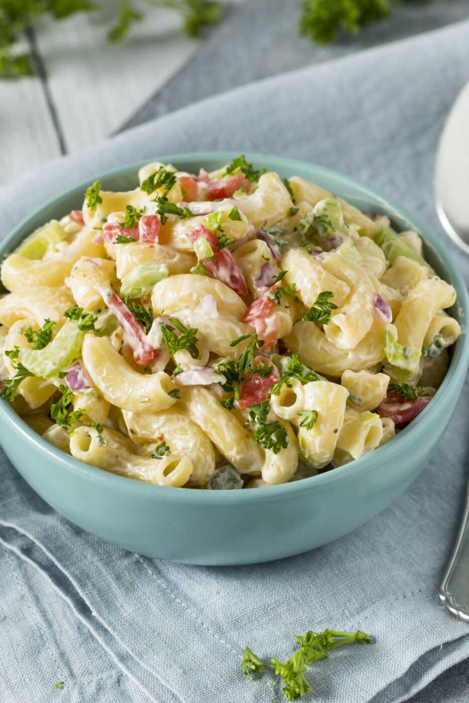 A bowl of creamy Hawaiian macaroni salad garnished with shredded carrots and green onions