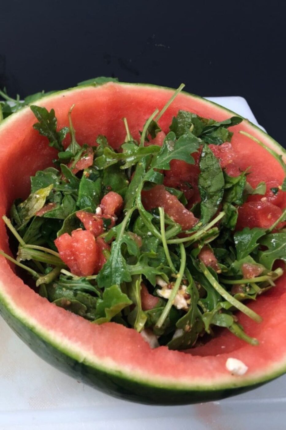 A vibrant bowl of watermelon feta salad with fresh mint and a light drizzle of dressing