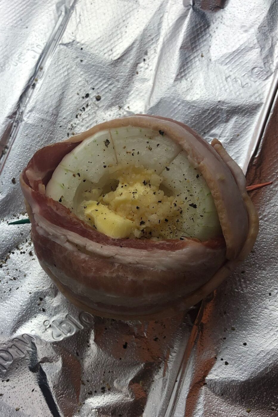 Whole roasted Vidalia onions wrapped in crispy bacon with caramelized garlic cloves