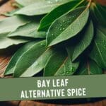 Close-up photo of several dried bay leaves on a light-colored wooden cutting board.