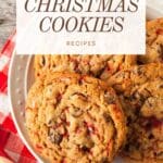 A plate of decadent Christmas cookies, including chocolate truffles and gingerbread houses