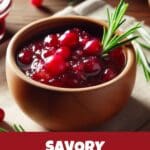 A close-up of a bowl of cranberry sauce with a sprig of rosemary on top.