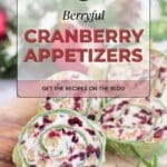 The image shows a cranberry walnut pinwheels on a wooden board.