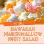 A bowl of marshmallow fruit salad with a variety of tropical fruits and a creamy dressing.