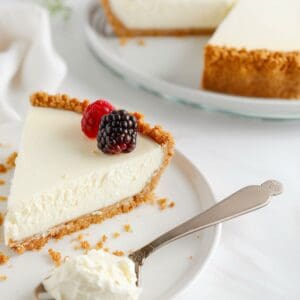 A thick and creamy no bake cheesecake with a smooth filling and a graham cracker crust, perfect for a rich and satisfying dessert.