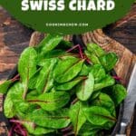 A photo of a bowl of swiss chard on a brown wooden table.