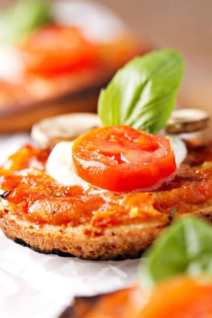Margherita pizza topped with a piece of basil