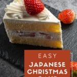 A slice of Japanese Christmas cake with a fluffy sponge cake base, candied fruits, and whipped cream frosting.