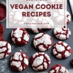 A photo of a vegan red velvet crinkle cookies arranged on a black slate countertop.
