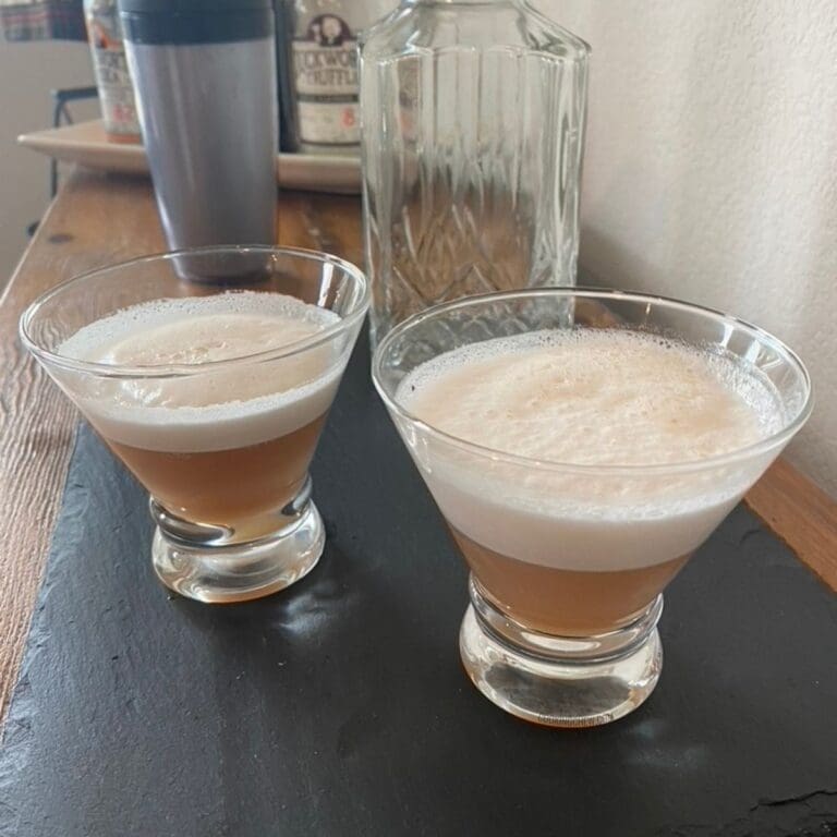 A sparkling pink fizz cocktail in a cosmopolitan glass.