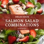 A bowl of salmon salad with strawberries, spinach, and feta cheese.