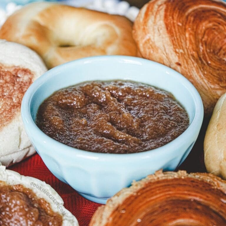 A close-up photo of a small, white bowl filled with apple butter.