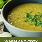 A bowl of split pea soup with cracker and brie cheese.