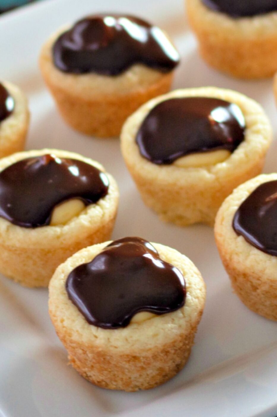 Golden-baked cookie cups filled with creamy custard and topped with a shiny chocolate glaze.