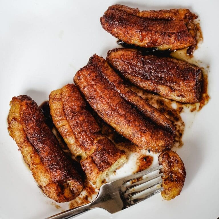 Cooked bananas fresh out of the air fryer, coated with brown sugar and cinnamon.