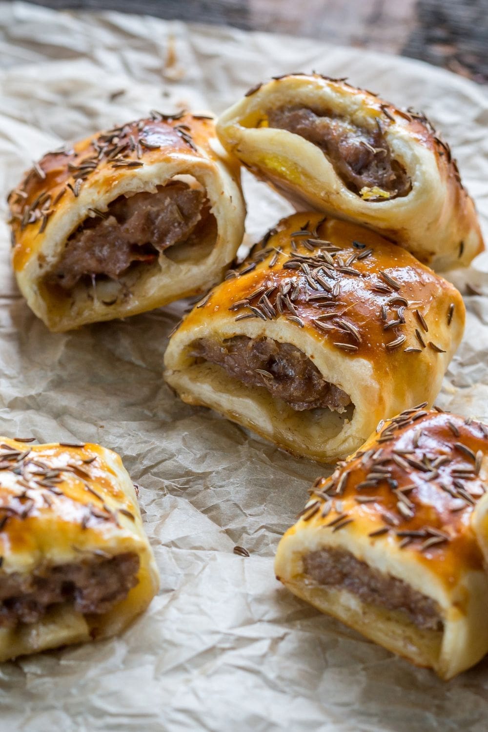 A plate of golden-brown English sausage rolls, freshly baked and ready to be enjoyed.