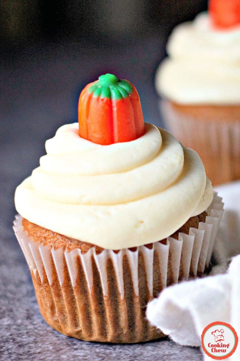 Spiced pumpkin cupcakes topped with fluffy cream cheese frosting, a perfect fall dessert.