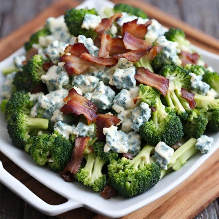 A close-up photo of a plate of broccoli salad with blue cheese and bacon.